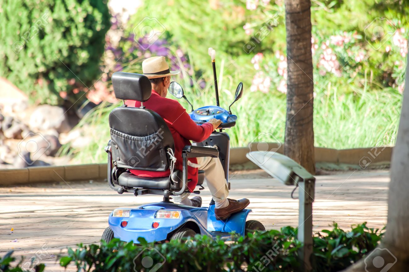 Senior man enjoying independence in an electric wheelchair