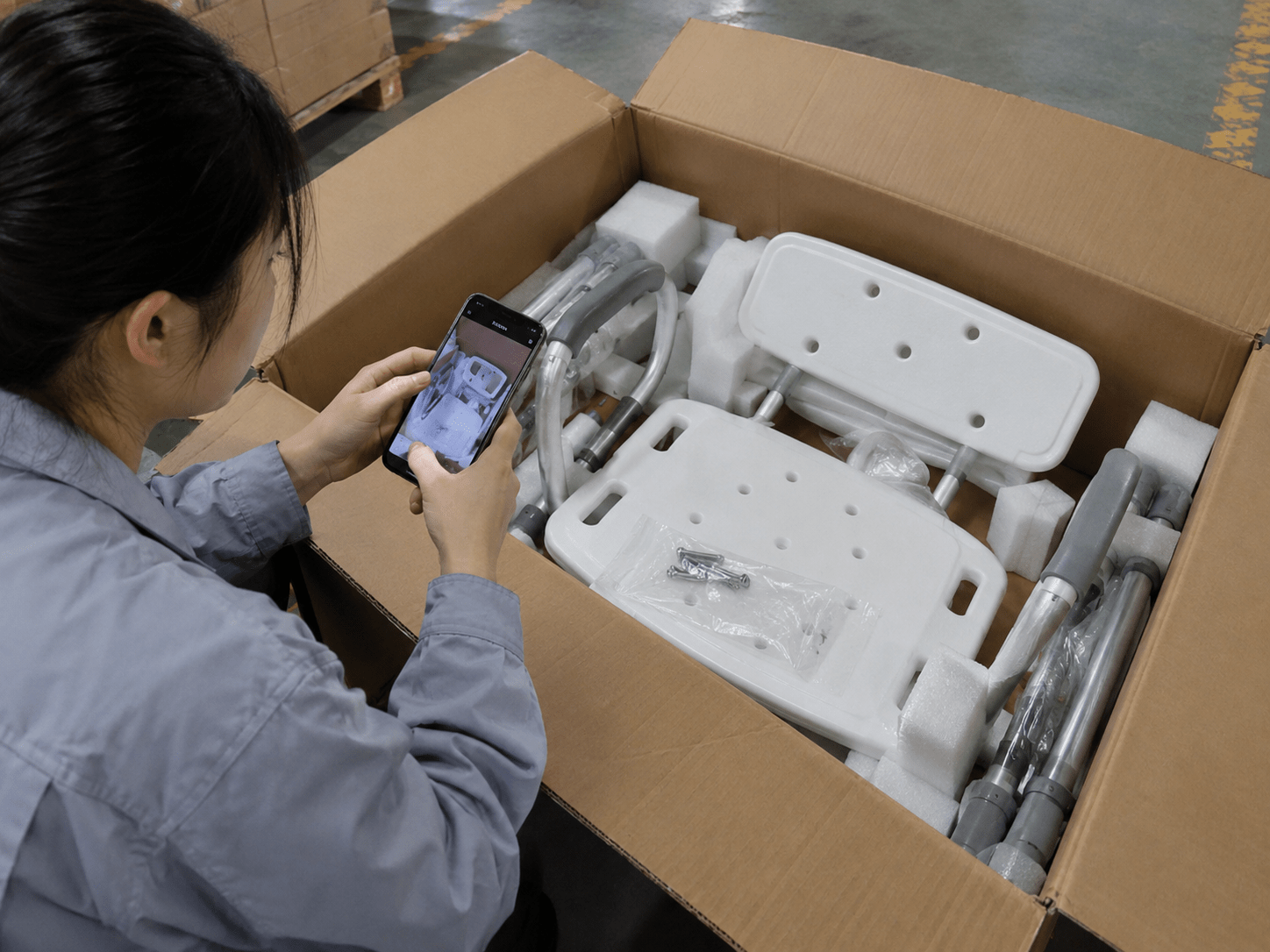 Opened carton with protected shower-chair components